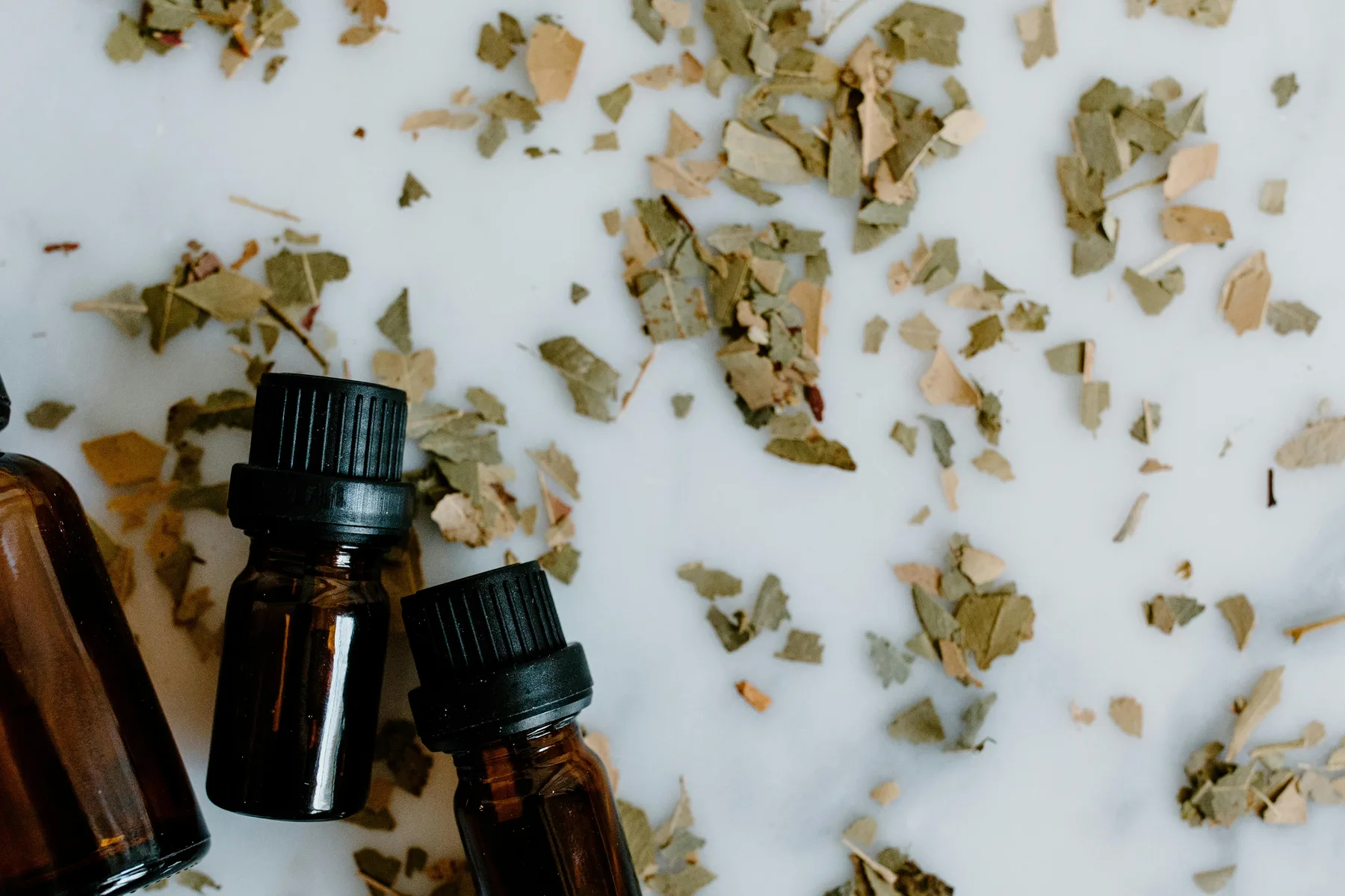 Wellness-inspired still life with herbal ingredients and essential oils.